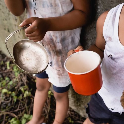 cropped-view-of-homeless-african-american-kids-holding-cup-and-metal-plate-while-begging-alms-on-1.jpg