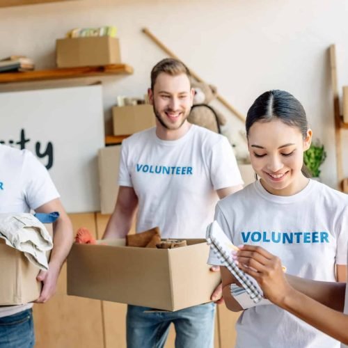 four-young-multicultural-volunteers-in-white-t-shirts-with-volunteer-inscriptions-working-in-charity-1.jpg