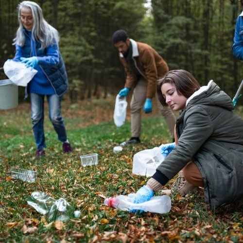 group-of-volunteers-cleaning-up-forest-from-waste-community-service-concept-e1659824078478.jpg